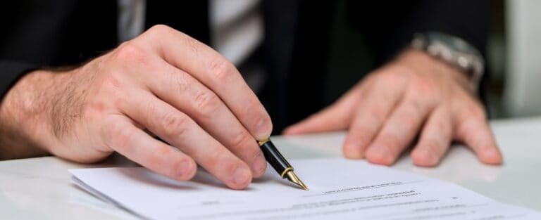 Business Man approve sign on business document.