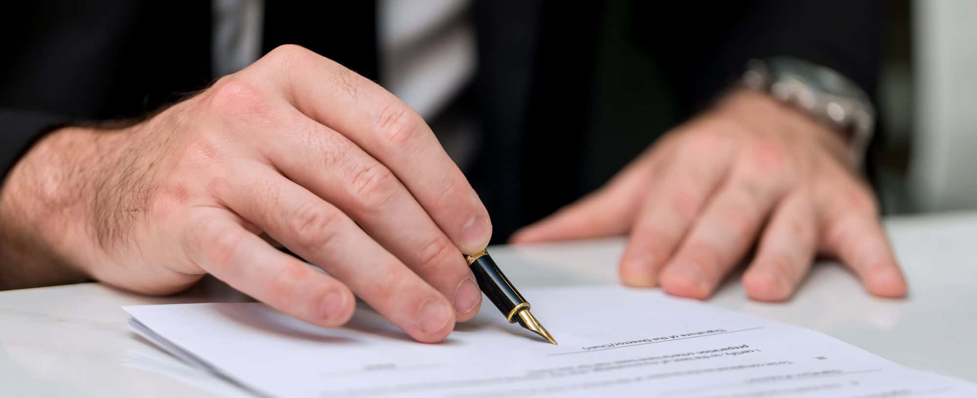 Business Man approve sign on business document.