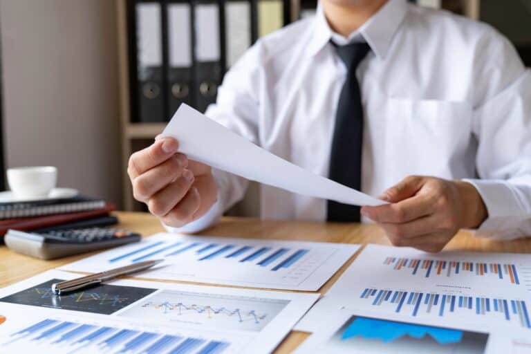 Close-up of businessman's hands collecting bills for tax refund and tax savings, finance banking and