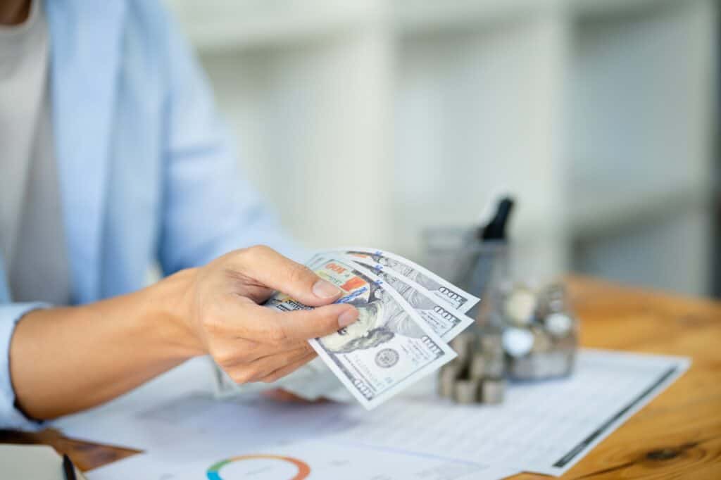 Saving money. Businessman Accountant verify growing business and saving money stacking